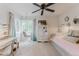 Bright bedroom featuring a hanging chair, wardrobe, ceiling fan, and a comfortable daybed with a decorative pillow at 8367 Devinney St, Arvada, CO 80005