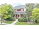 Charming two-story home with a covered porch and well-manicured lawn at 8367 Devinney St, Arvada, CO 80005