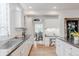 Bright kitchen features white cabinets, stainless steel sink, and a built-in desk area at 8367 Devinney St, Arvada, CO 80005