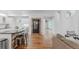 Spacious living room with hardwood floors, a large kitchen island, and modern decor, offering a cozy and inviting atmosphere at 8367 Devinney St, Arvada, CO 80005