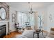 Bright living room with fireplace, large windows, and comfortable seating at 8367 Devinney St, Arvada, CO 80005