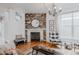 Cozy living room with a fireplace, modern lighting, and stylish decor at 8367 Devinney St, Arvada, CO 80005