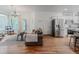 Open-concept living area with kitchen, hardwood floors and plenty of natural light at 8367 Devinney St, Arvada, CO 80005