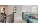 Spacious upper living space with stylish decor, a comfortable blue sofa, and stairs leading to another level at 8367 Devinney St, Arvada, CO 80005
