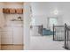 Bright living space with laundry area, leading to a cozy seating area with a blue sofa and ottoman at 8367 Devinney St, Arvada, CO 80005