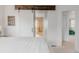 Bright main bedroom with a sliding barn door, neutral decor, and a glimpse of the ensuite bathroom, creating a tranquil oasis at 8367 Devinney St, Arvada, CO 80005