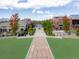 Picturesque street view showcases homes and landscaped common area with a sidewalk through the community at 8367 Devinney St, Arvada, CO 80005
