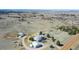 This aerial view reveals an expansive property with multiple buildings, a long driveway, and surrounding open land at 2257 Deerpath Rd, Franktown, CO 80116