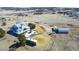 An aerial shot shows a home with outbuildings, a patio, an RV, and a spacious yard, offering versatile outdoor living at 2257 Deerpath Rd, Franktown, CO 80116
