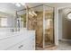 Modern bathroom featuring tiled walk-in shower and white vanity with marble countertop at 2257 Deerpath Rd, Franktown, CO 80116