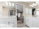 Bright, dual-sink bathroom with white cabinetry and neutral walls flows into the living area at 2257 Deerpath Rd, Franktown, CO 80116