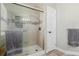Modern bathroom shower features tile surround and glass door at 2257 Deerpath Rd, Franktown, CO 80116