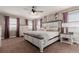 Bright bedroom with large windows and a comfortable bed featuring a decorative headboard at 2257 Deerpath Rd, Franktown, CO 80116