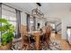 Cozy dining room with rustic wooden table and chairs, stylish lighting, and decorative rug at 2257 Deerpath Rd, Franktown, CO 80116