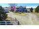 Charming two-story home with a circular driveway, lush lawn and inviting wrap-around porch at 2257 Deerpath Rd, Franktown, CO 80116