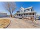 Stately two-story home featuring an expansive wraparound porch and detached garage, perfect for country living at 2257 Deerpath Rd, Franktown, CO 80116