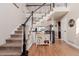 Bright foyer featuring hardwood floors, staircase with decorative railing, and charming decor at 2257 Deerpath Rd, Franktown, CO 80116