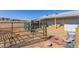 This image shows a fenced horse area with hay bales and a building in the background, perfect for equestrian enthusiasts at 2257 Deerpath Rd, Franktown, CO 80116
