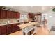 Spacious kitchen featuring a center island, stone backsplash, and stainless steel refrigerator at 2257 Deerpath Rd, Franktown, CO 80116