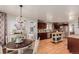 Open kitchen with dining area featuring updated appliances, modern lighting, and plenty of countertop space at 2257 Deerpath Rd, Franktown, CO 80116