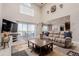 Open living room featuring high ceilings, cozy seating, large windows, and access to outdoor balcony at 2257 Deerpath Rd, Franktown, CO 80116