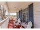 Relaxing porch with white rocking chairs and side table, providing serene outdoor living space at 2257 Deerpath Rd, Franktown, CO 80116