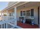 Covered porch featuring a grill and seating area at 2257 Deerpath Rd, Franktown, CO 80116