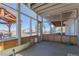 View from the sunroom showing the patio, camper, and a basketball court at 2257 Deerpath Rd, Franktown, CO 80116