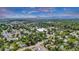 Expansive aerial view of the neighborhood, showcasing the home's location amidst lush greenery and nearby mountains at 211 E Emma St, Lafayette, CO 80026