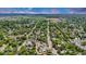 Expansive aerial view of a tree-lined neighborhood with single-Gathering homes and distant fields under a blue sky at 211 E Emma St, Lafayette, CO 80026