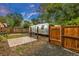 Backyard featuring a classic Airstream trailer with fence, patio, and a well-maintained gate at 211 E Emma St, Lafayette, CO 80026