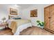 Comfortable bedroom with hardwood floors, stylish decor, and ample natural light, creating a relaxing retreat at 211 E Emma St, Lafayette, CO 80026