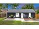 Charming home featuring dark siding, a well-kept lawn, patio, and white door at 211 E Emma St, Lafayette, CO 80026