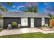 Charming home featuring a dark exterior, well-kept lawn, and a cozy patio area at 211 E Emma St, Lafayette, CO 80026