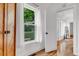 Bright hallway with hardwood floors, white walls, and an open doorway, enhancing the home's flow and spaciousness at 211 E Emma St, Lafayette, CO 80026