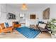 Stylish living room with leather chairs, hardwood floors, and decor at 211 E Emma St, Lafayette, CO 80026