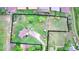 Aerial view of property with a large fenced yard, mature trees, and gravel driveway at 5870 Nelson Ct, Arvada, CO 80004