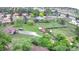 Aerial view of property with a large yard, mature trees, sheds, and gravel driveway at 5870 Nelson Ct, Arvada, CO 80004