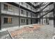 Apartment complex courtyard features rock landscaping with metal stairs and black metal guardrails at 336 N Grant St # 302, Denver, CO 80203