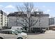 View of the apartment building with large tree in front of the entrance at 336 N Grant St # 302, Denver, CO 80203