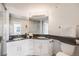 Bright bathroom features dual sinks, granite counters and a glass enclosed shower at 111 S Monroe St # B203, Denver, CO 80209