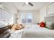 Comfortable bedroom with a large window, stylish decor, and ample natural light at 111 S Monroe St # B203, Denver, CO 80209