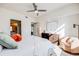 Spacious bedroom featuring a large window, dresser, and doorway to an ensuite bathroom at 111 S Monroe St # B203, Denver, CO 80209