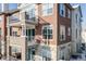 Exterior view of a brick building with balconies at 111 S Monroe St # B203, Denver, CO 80209
