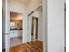 Hallway with hardwood floors, showing entrances to a bathroom and a closet at 111 S Monroe St # B203, Denver, CO 80209