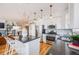 Open kitchen featuring stainless appliances, granite countertops, island with seating, and stylish decor at 111 S Monroe St # B203, Denver, CO 80209