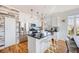Modern kitchen features stainless steel appliances, granite countertops, island, and decorative lighting at 111 S Monroe St # B203, Denver, CO 80209