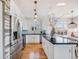 Bright kitchen area with stainless steel appliances, an island, and ample natural lighting at 111 S Monroe St # B203, Denver, CO 80209