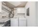 Functional laundry room with washer, dryer, and storage shelves at 111 S Monroe St # B203, Denver, CO 80209