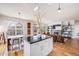 Open concept living space with hardwood floors, fireplace, and dining area with natural light at 111 S Monroe St # B203, Denver, CO 80209